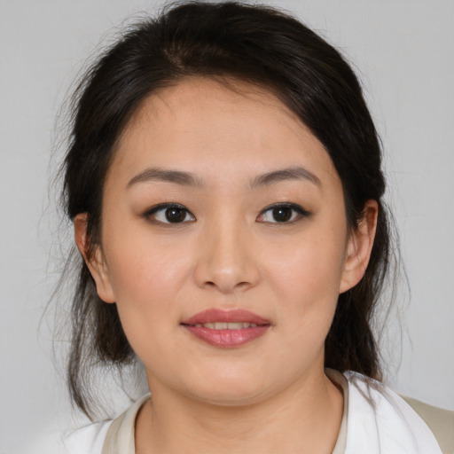 Joyful asian young-adult female with medium  brown hair and brown eyes