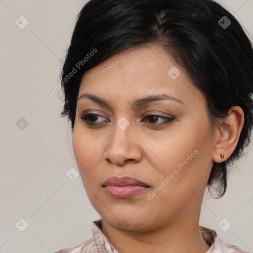 Joyful latino young-adult female with medium  brown hair and brown eyes