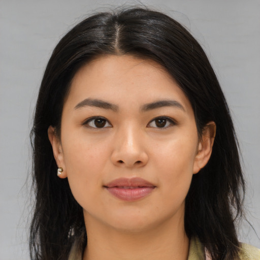 Joyful asian young-adult female with long  brown hair and brown eyes