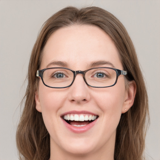 Joyful white young-adult female with long  brown hair and blue eyes