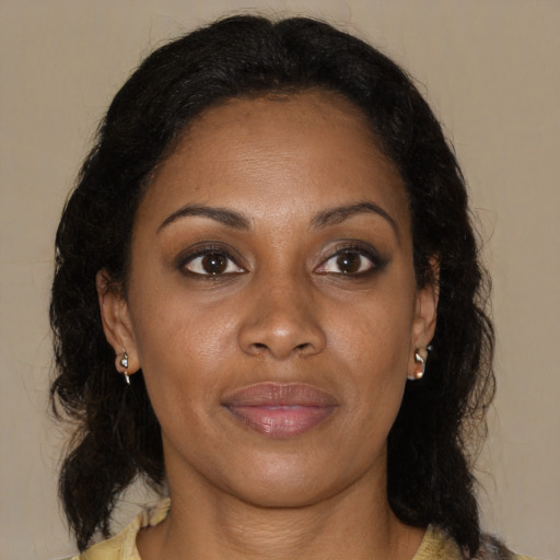 Joyful black young-adult female with medium  brown hair and brown eyes