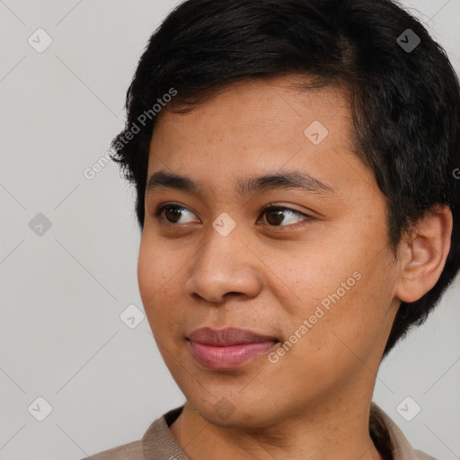 Joyful black young-adult male with short  black hair and brown eyes