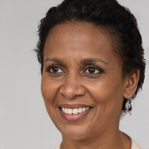 Joyful black adult female with short  brown hair and brown eyes