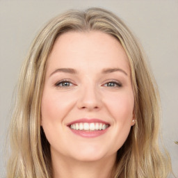 Joyful white young-adult female with long  brown hair and blue eyes