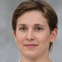 Joyful white adult female with short  brown hair and grey eyes