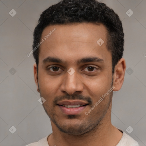 Joyful black young-adult male with short  black hair and brown eyes