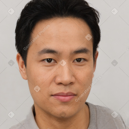 Joyful asian young-adult male with short  black hair and brown eyes