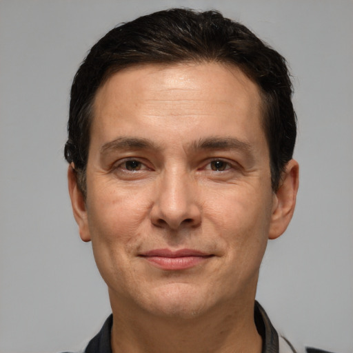 Joyful white adult male with short  brown hair and brown eyes