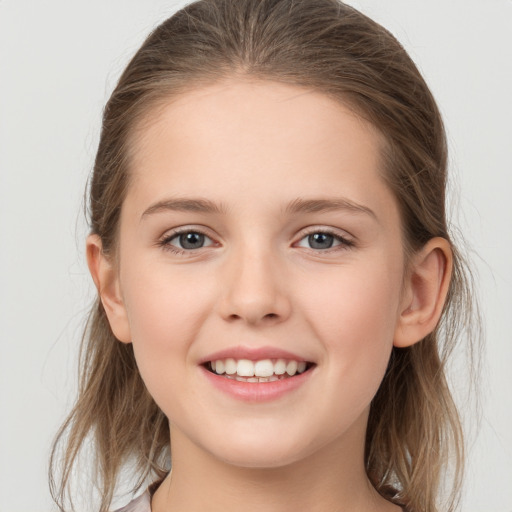 Joyful white child female with medium  brown hair and grey eyes