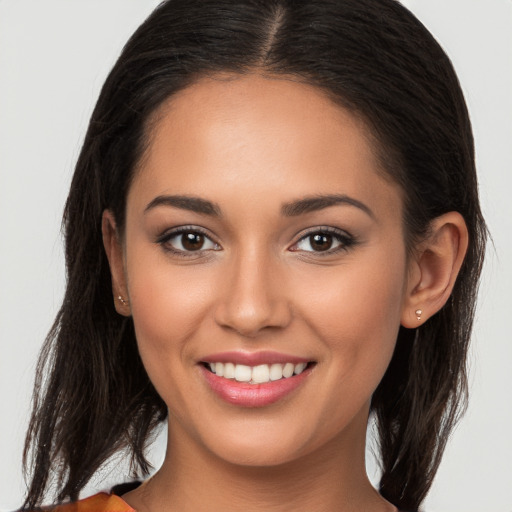 Joyful white young-adult female with long  brown hair and brown eyes