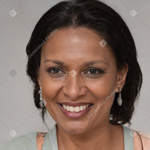 Joyful black adult female with medium  brown hair and brown eyes