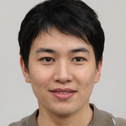 Joyful asian young-adult male with short  brown hair and brown eyes