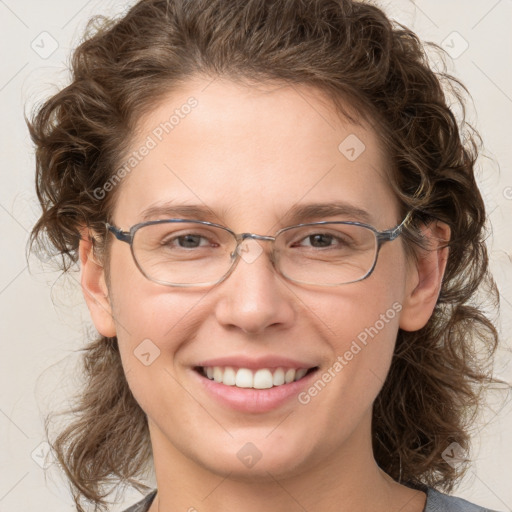 Joyful white adult female with medium  brown hair and grey eyes