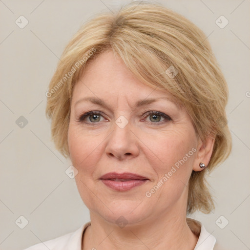 Joyful white adult female with medium  brown hair and blue eyes