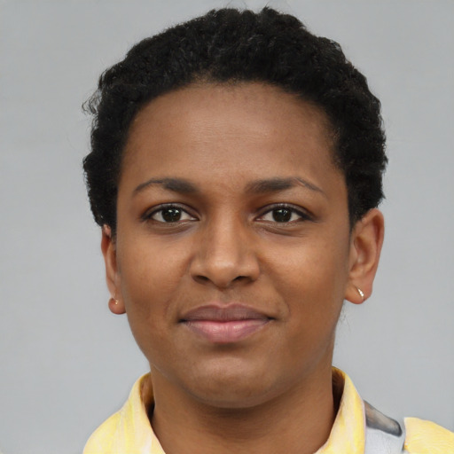 Joyful black young-adult female with short  brown hair and brown eyes