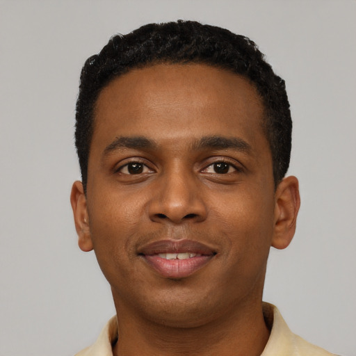 Joyful black young-adult male with short  black hair and brown eyes