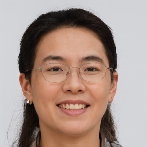 Joyful asian adult female with long  brown hair and brown eyes