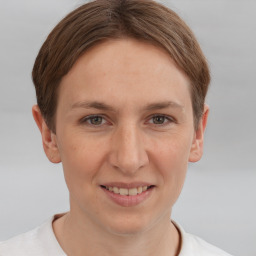 Joyful white young-adult female with short  brown hair and grey eyes