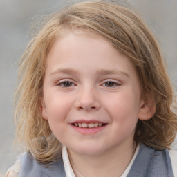 Joyful white child female with medium  brown hair and grey eyes