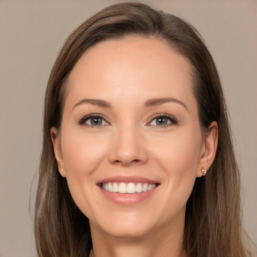 Joyful white young-adult female with long  brown hair and brown eyes