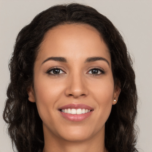 Joyful white young-adult female with long  brown hair and brown eyes