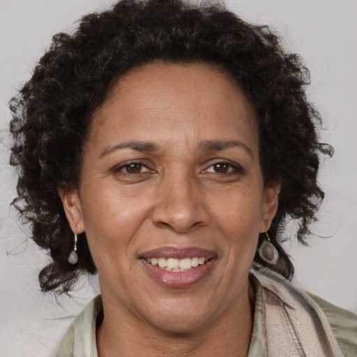 Joyful black adult female with short  brown hair and brown eyes