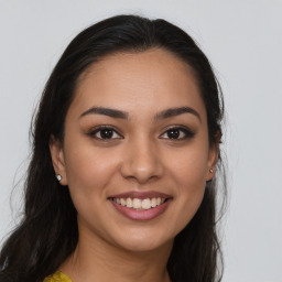 Joyful white young-adult female with long  brown hair and brown eyes