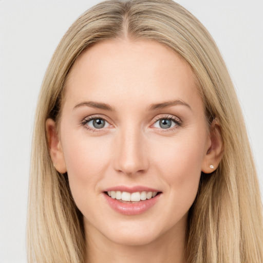 Joyful white young-adult female with long  brown hair and blue eyes