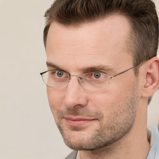 Joyful white adult male with short  brown hair and brown eyes