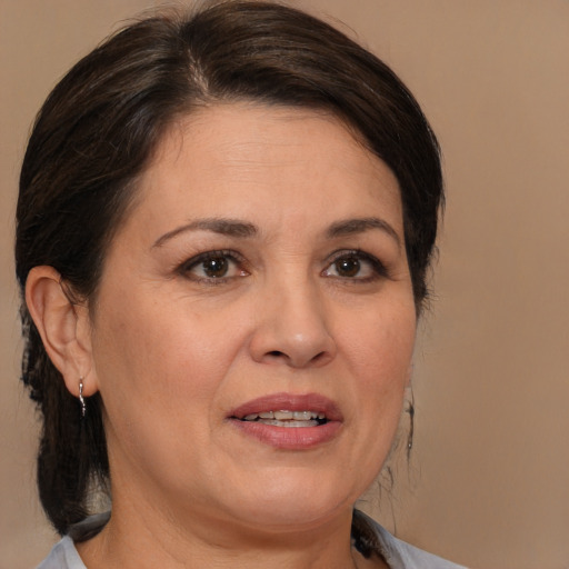 Joyful white adult female with medium  brown hair and brown eyes