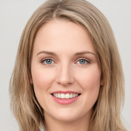 Joyful white young-adult female with long  brown hair and green eyes