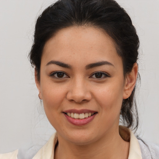 Joyful latino young-adult female with medium  brown hair and brown eyes