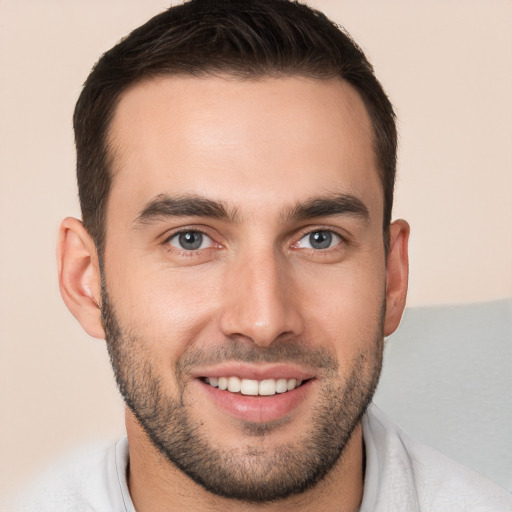 Joyful white young-adult male with short  brown hair and brown eyes