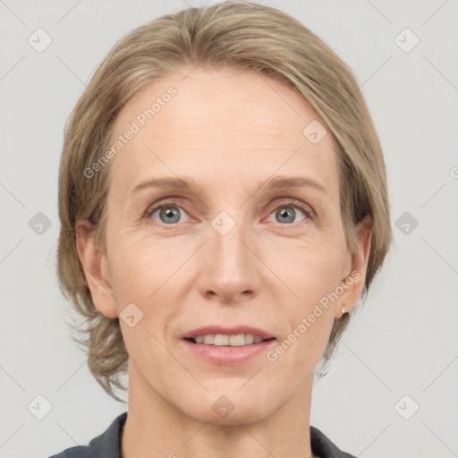 Joyful white adult female with medium  brown hair and grey eyes