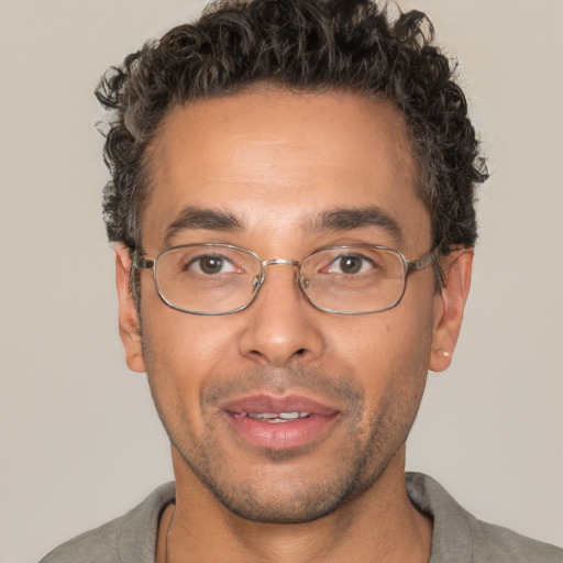 Joyful white adult male with short  brown hair and brown eyes