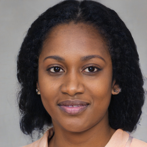 Joyful black young-adult female with medium  black hair and brown eyes