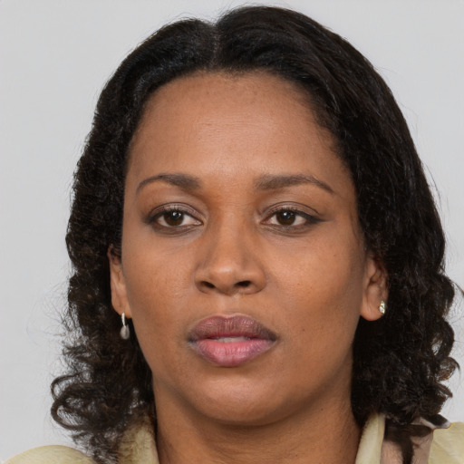 Neutral black adult female with medium  brown hair and brown eyes