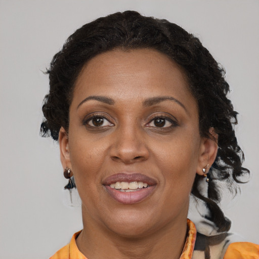 Joyful black adult female with short  brown hair and brown eyes