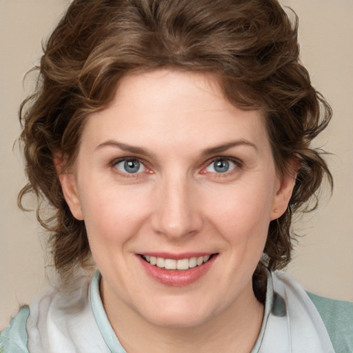 Joyful white young-adult female with medium  brown hair and blue eyes