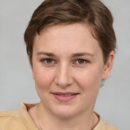 Joyful white young-adult female with short  brown hair and grey eyes