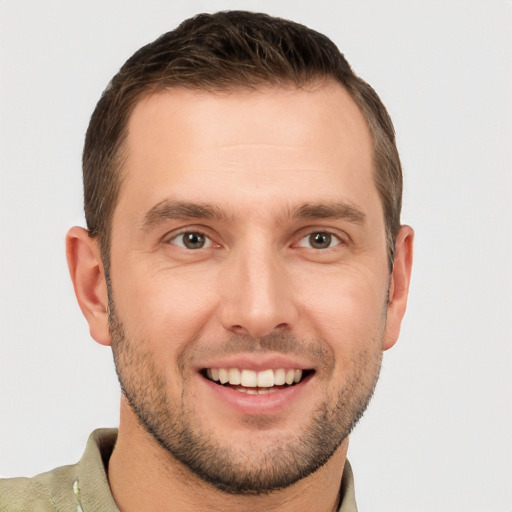 Joyful white young-adult male with short  brown hair and brown eyes