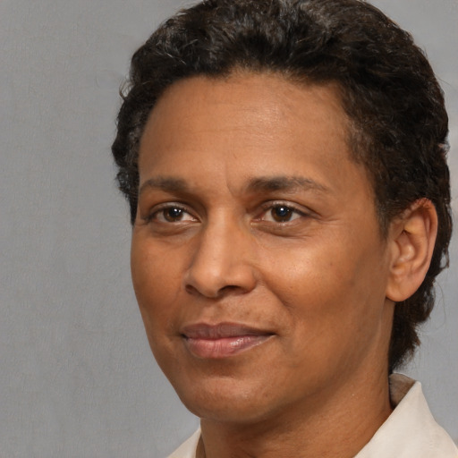 Joyful black adult male with short  brown hair and brown eyes