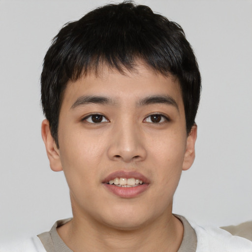 Joyful asian young-adult male with short  black hair and brown eyes