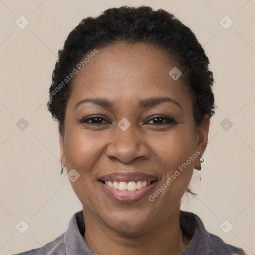 Joyful black adult female with short  brown hair and brown eyes