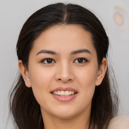 Joyful white young-adult female with long  brown hair and brown eyes