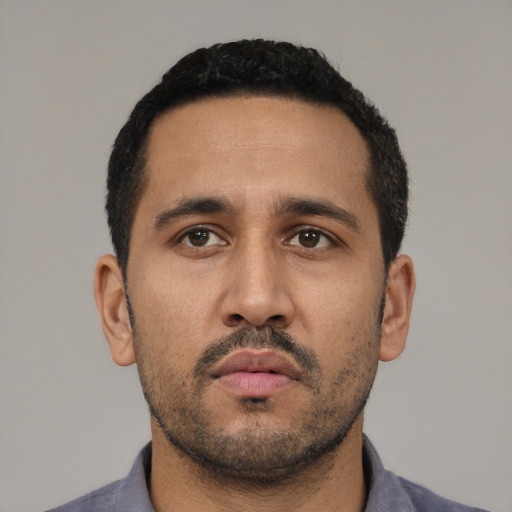 Neutral latino young-adult male with short  black hair and brown eyes