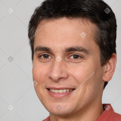 Joyful white adult male with short  brown hair and brown eyes