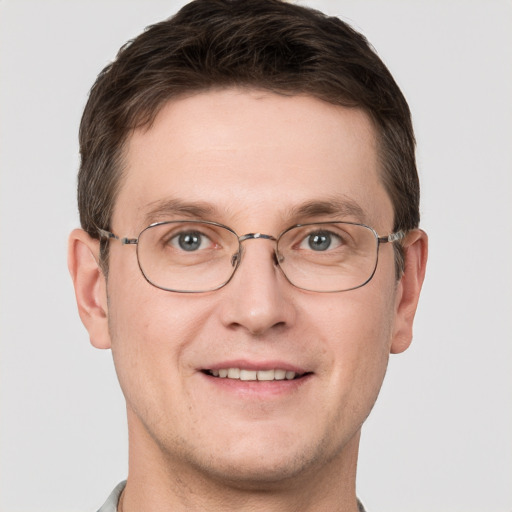 Joyful white adult male with short  brown hair and grey eyes