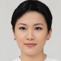 Joyful asian young-adult female with short  black hair and brown eyes