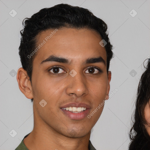 Joyful latino young-adult male with short  brown hair and brown eyes